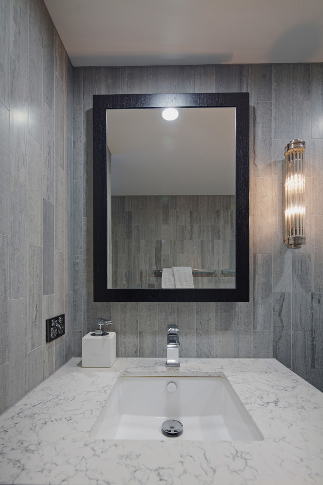 This is an example of a small contemporary 3/4 bathroom in Sydney with shaker cabinets, black cabinets, an alcove shower, a one-piece toilet, gray tile, travertine, grey walls, marble floors, an undermount sink, engineered quartz benchtops, grey floor and a sliding shower screen.