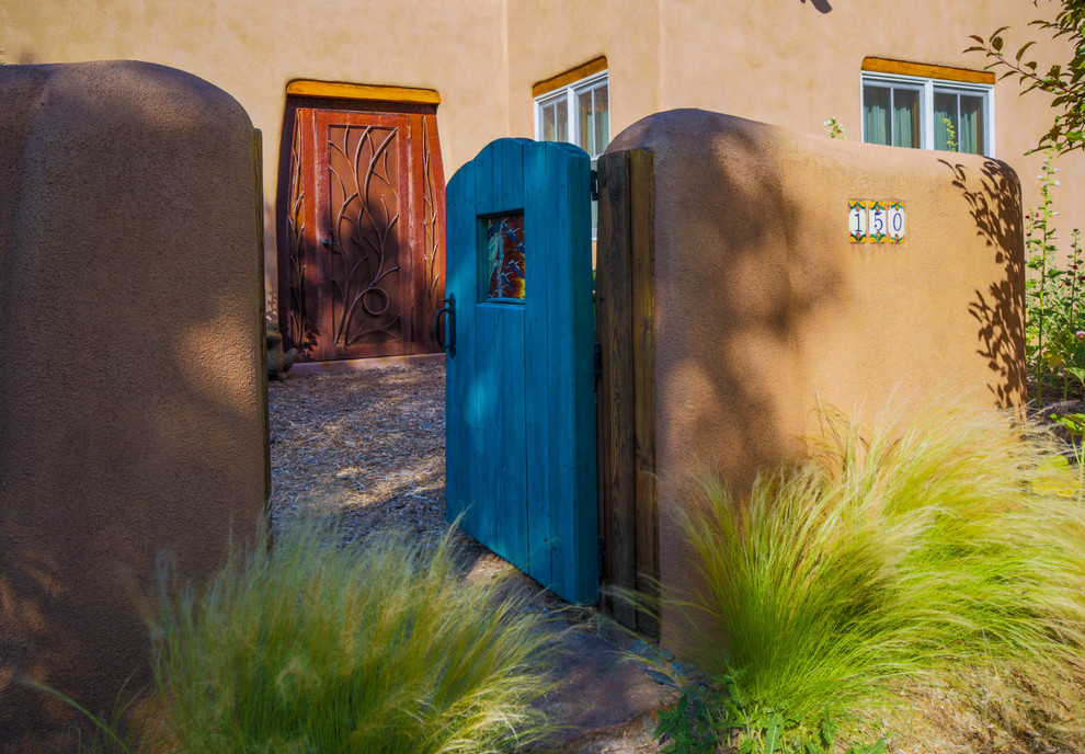 Inspiration for a mid-sized one-storey adobe exterior in Albuquerque.