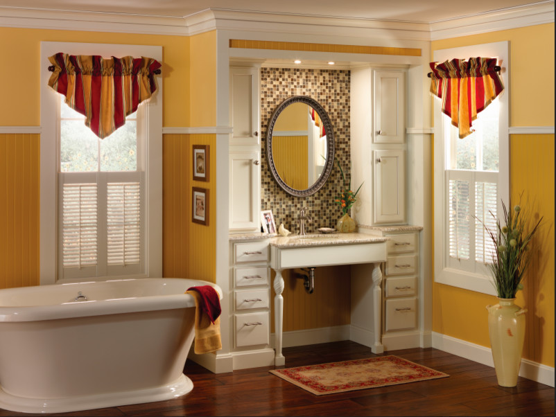 Example of a mid-sized transitional master mosaic tile dark wood floor and brown floor freestanding bathtub design with flat-panel cabinets, white cabinets, yellow walls, an undermount sink and granite countertops