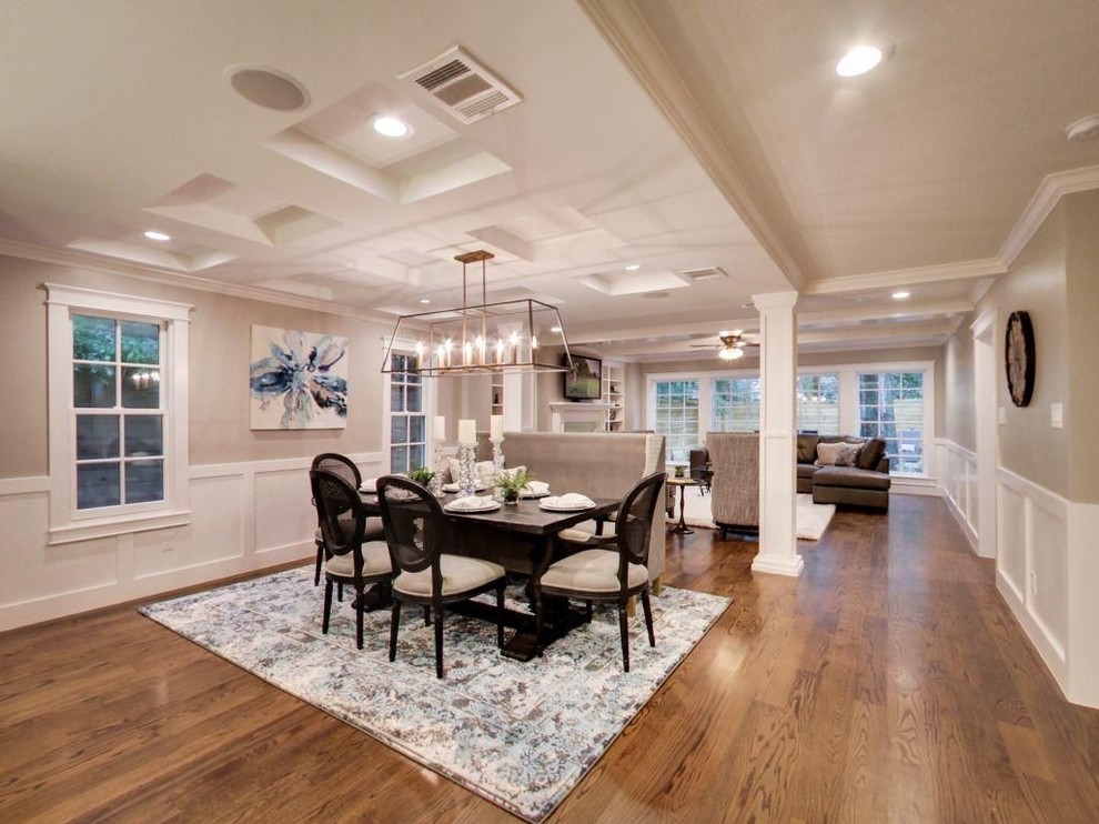 Example of a mid-sized transitional medium tone wood floor and brown floor great room design with beige walls and no fireplace