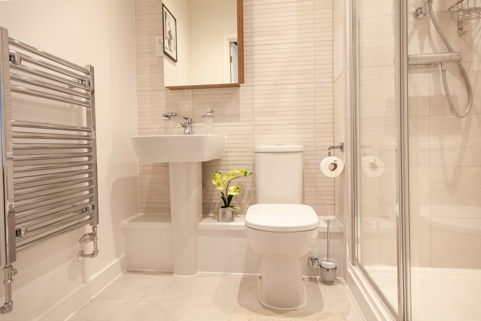 Design ideas for a small modern master bathroom in London with glass-front cabinets, light wood cabinets, a curbless shower, a one-piece toilet, gray tile, ceramic tile, white walls, cement tiles, a drop-in sink, grey floor, a sliding shower screen, a single vanity and a floating vanity.