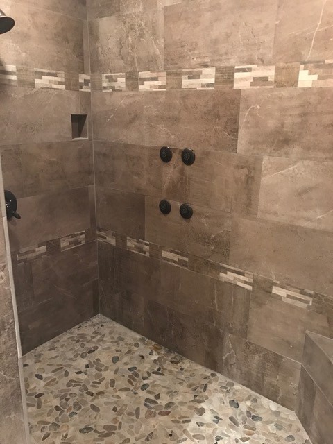 Corner shower - transitional brown tile and marble tile corner shower idea in Denver