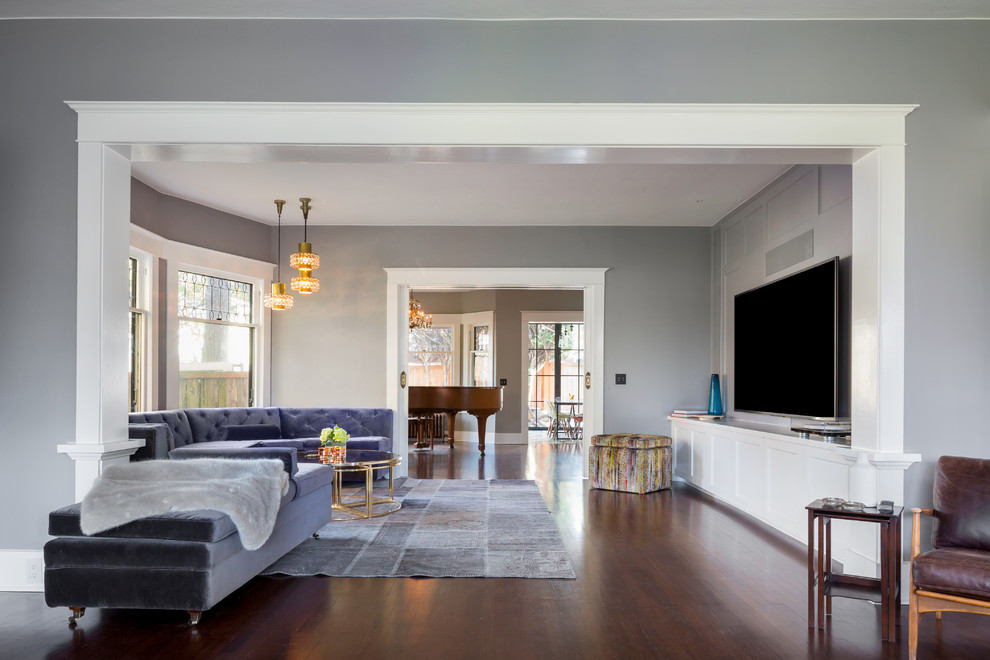 Design ideas for a transitional living room in Seattle with grey walls, medium hardwood floors and a wall-mounted tv.