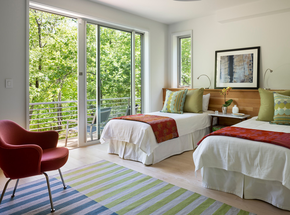 Inspiration for a mid-sized transitional master bedroom in New York with white walls and light hardwood floors.