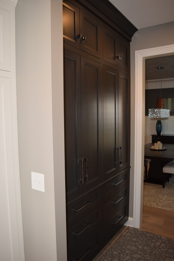 Eat-in kitchen - large transitional l-shaped light wood floor and multicolored floor eat-in kitchen idea in Chicago with beaded inset cabinets, white cabinets, quartz countertops, black backsplash, ceramic backsplash, stainless steel appliances and an island