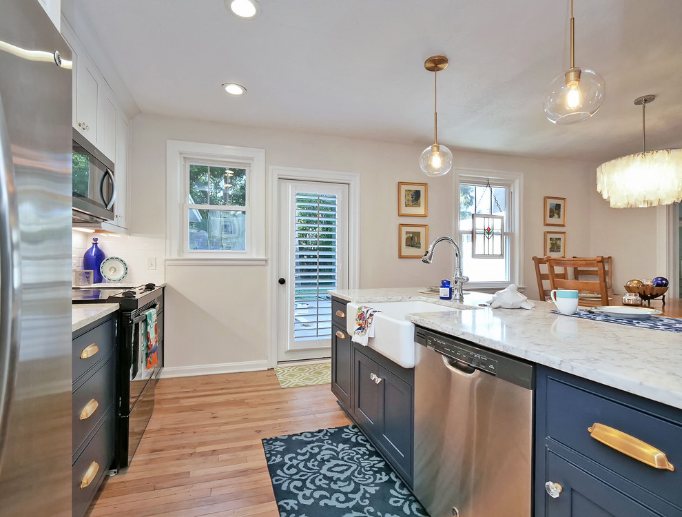 Example of a small beach style galley medium tone wood floor and beige floor eat-in kitchen design in Jacksonville with a farmhouse sink, beaded inset cabinets, blue cabinets, quartz countertops, white backsplash, subway tile backsplash, stainless steel appliances, a peninsula and white countertops