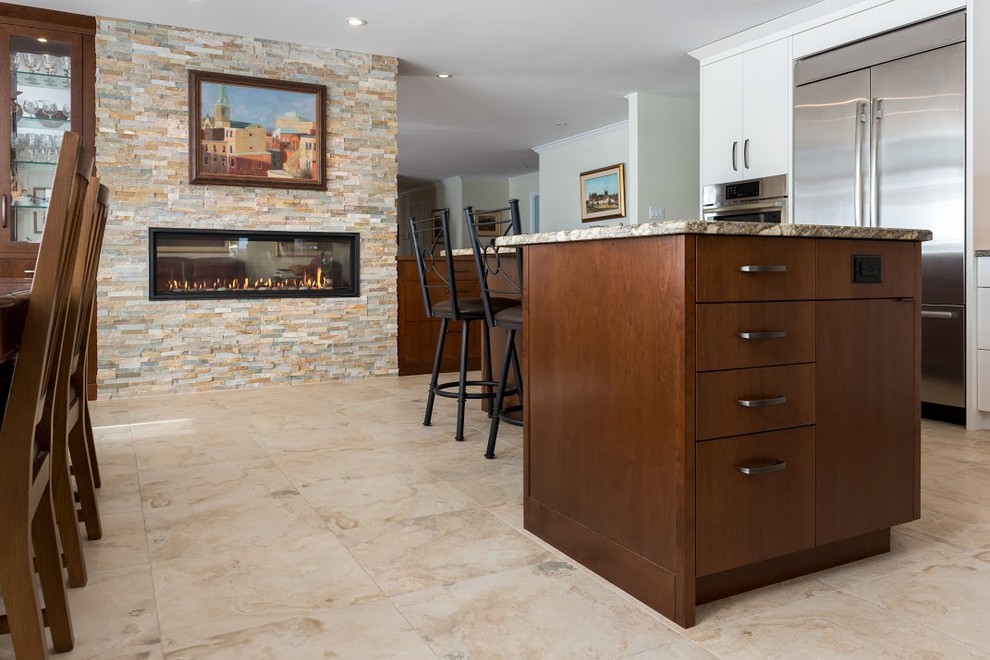 Large transitional l-shaped marble floor eat-in kitchen photo in Toronto with an undermount sink, flat-panel cabinets, white cabinets, granite countertops, white backsplash, subway tile backsplash, stainless steel appliances and an island