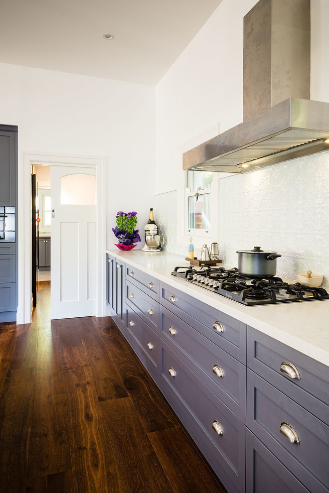 This is an example of a transitional kitchen in Melbourne with recessed-panel cabinets, blue cabinets, granite benchtops, with island and white splashback.