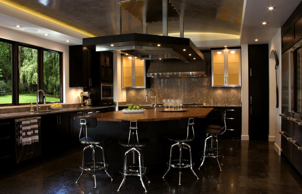 Example of a large trendy u-shaped eat-in kitchen design with flat-panel cabinets, dark wood cabinets, beige backsplash, white walls and an island