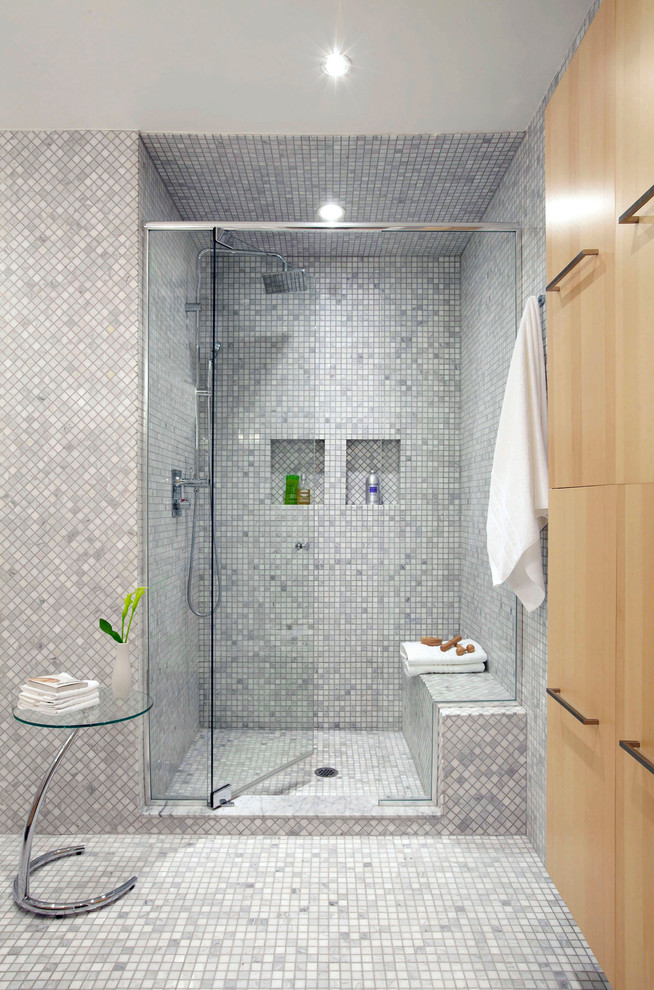 This is an example of a mid-sized contemporary master bathroom in Toronto with an alcove shower, gray tile, marble, grey walls, marble floors, grey floor and a hinged shower door.