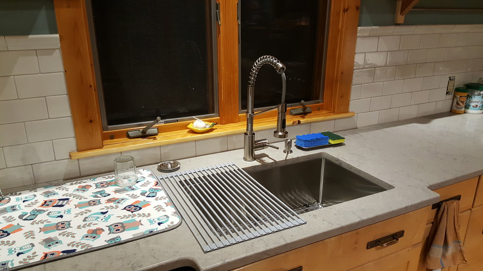 Inspiration for a mid-sized rustic u-shaped terra-cotta tile and beige floor eat-in kitchen remodel with an undermount sink, shaker cabinets, light wood cabinets, quartz countertops, white backsplash, subway tile backsplash, stainless steel appliances, a peninsula and gray countertops