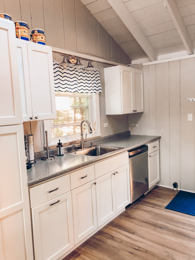 Inspiration for a small nautical galley kitchen in Portland Maine with shaker cabinets and laminate countertops.
