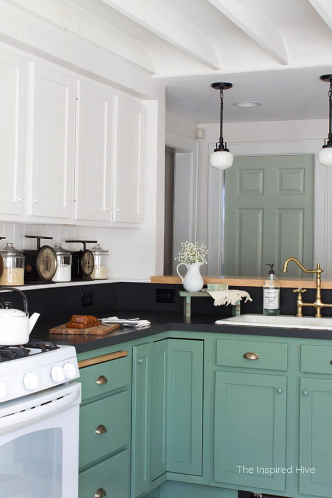 Photo of a country l-shaped kitchen in Los Angeles with shaker cabinets, a drop-in sink, green cabinets and black benchtop.