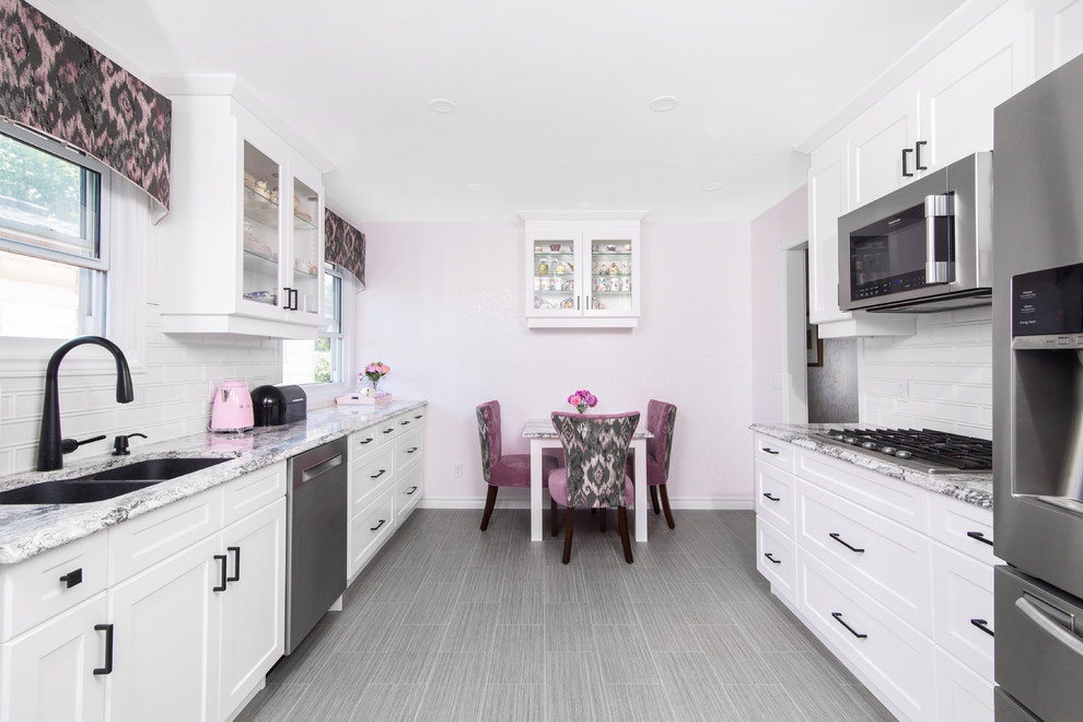 Eat-in kitchen - mid-sized transitional galley porcelain tile and gray floor eat-in kitchen idea with a double-bowl sink, shaker cabinets, white cabinets, granite countertops, white backsplash, subway tile backsplash, stainless steel appliances, no island and gray countertops