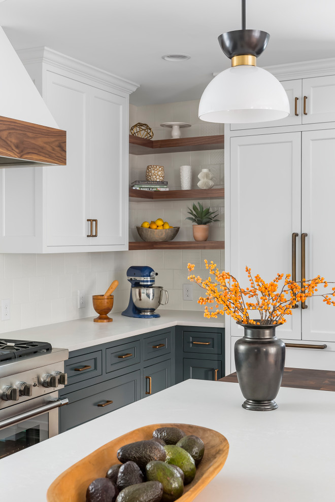 Example of a large transitional l-shaped dark wood floor and brown floor eat-in kitchen design in Minneapolis with an undermount sink, flat-panel cabinets, blue cabinets, quartz countertops, white backsplash, ceramic backsplash, paneled appliances, an island and white countertops