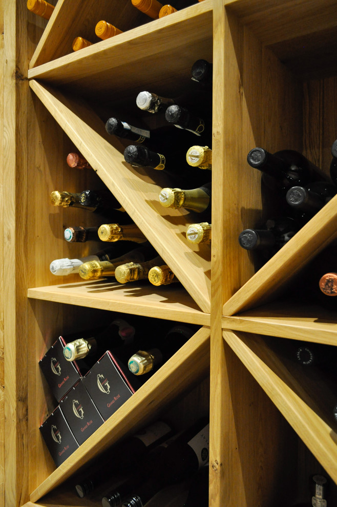 Inspiration for a large traditional wine cellar in Other with limestone floors and beige floor.