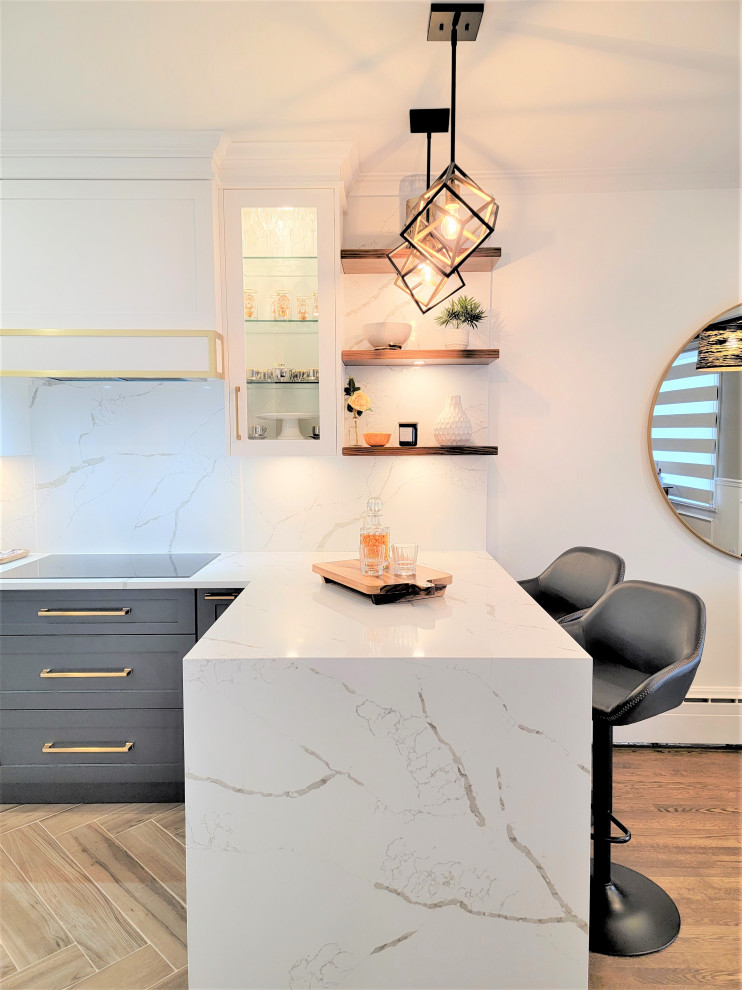 Eat-in kitchen - mid-sized transitional galley porcelain tile and brown floor eat-in kitchen idea in Montreal with an undermount sink, shaker cabinets, blue cabinets, quartz countertops, white backsplash, quartz backsplash, stainless steel appliances, a peninsula and white countertops