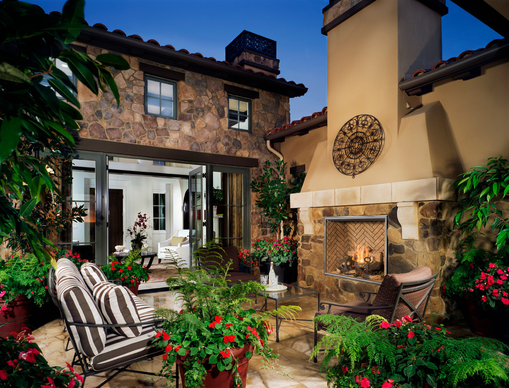 Mediterranean patio in Sacramento with a fire feature and no cover.