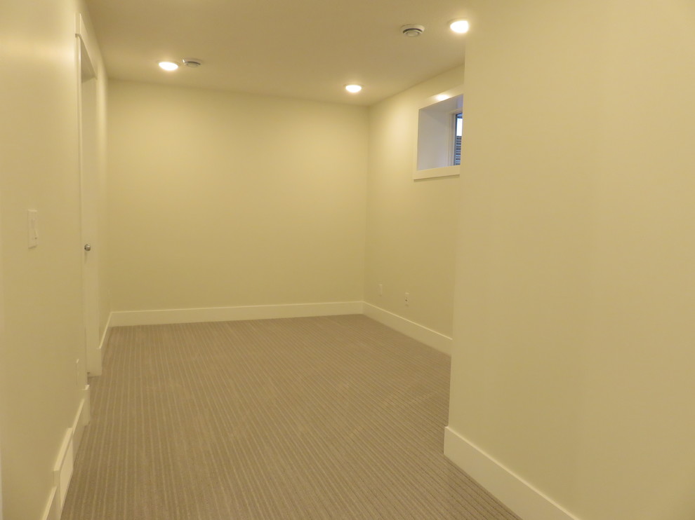 Inspiration for a small transitional look-out carpeted and gray floor basement remodel in Calgary with white walls
