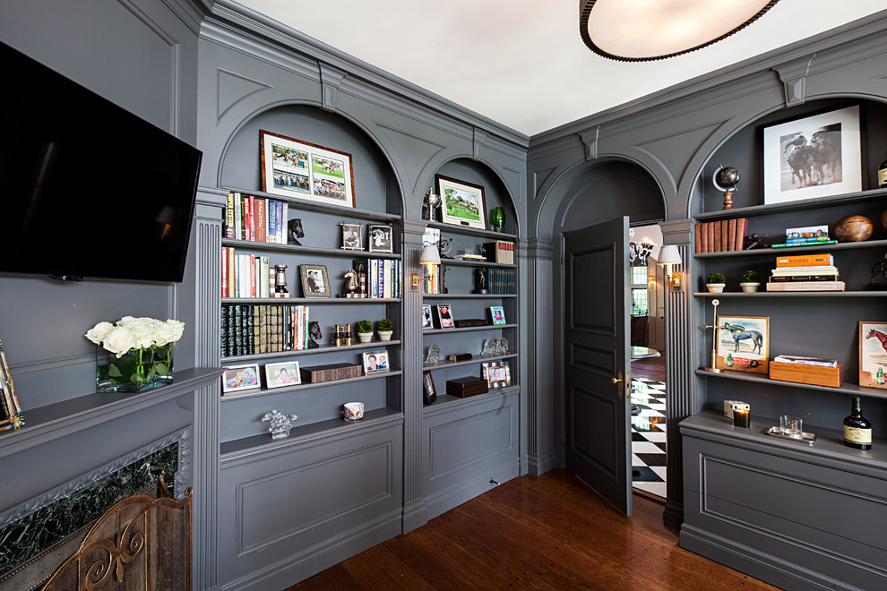 This is an example of a transitional home office in New York with grey walls and a corner fireplace.
