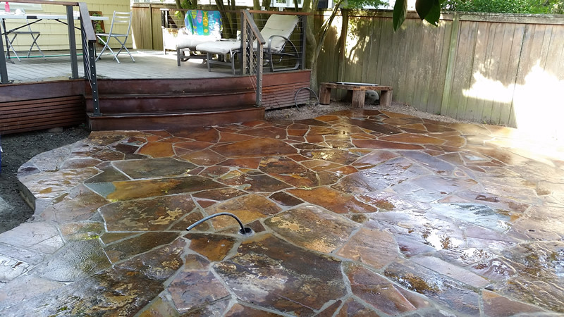 Mid-sized traditional backyard patio in Seattle with natural stone pavers.