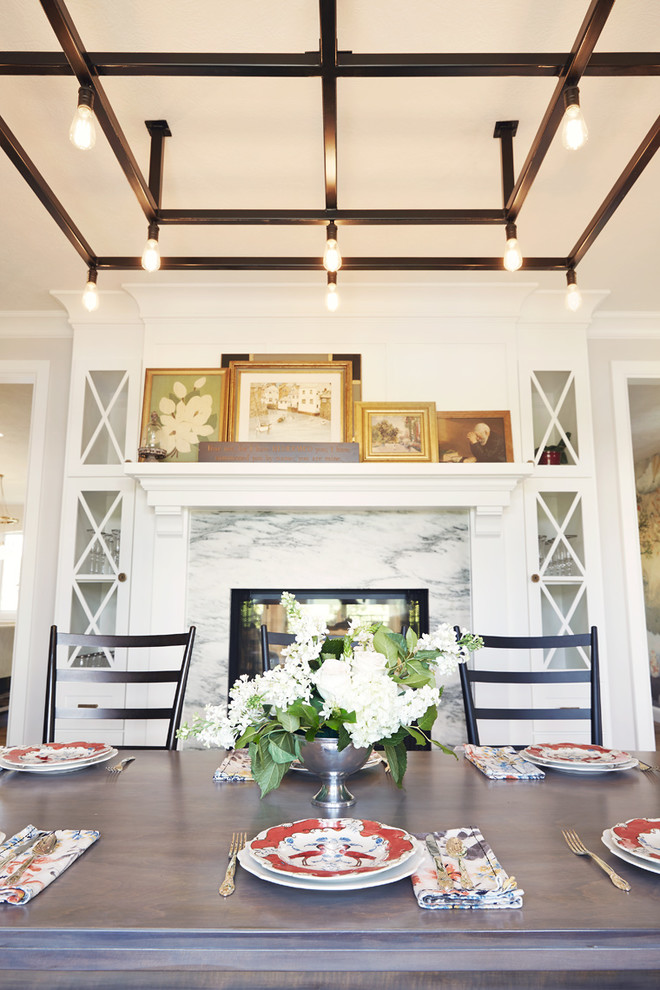 Example of a large mountain style medium tone wood floor great room design with white walls, a two-sided fireplace and a wood fireplace surround