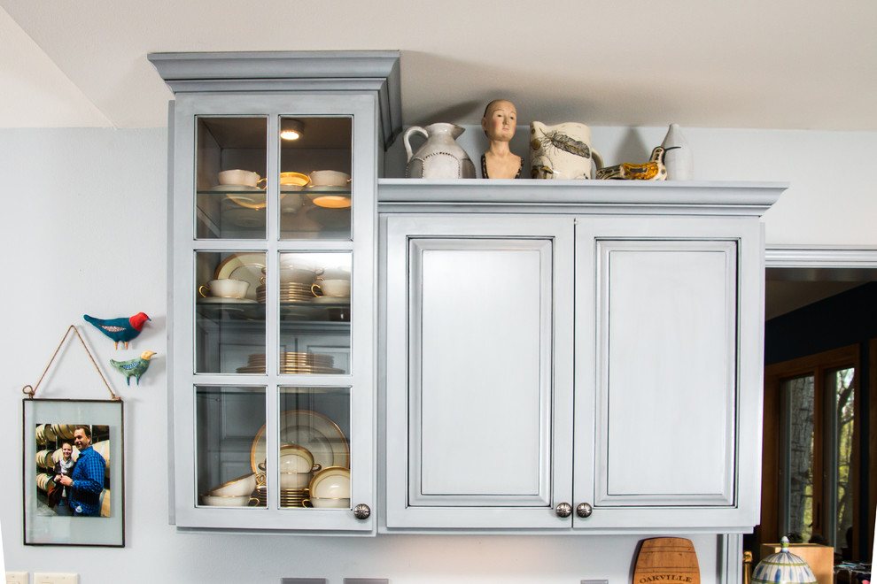 Inspiration for a large transitional u-shaped porcelain tile and beige floor eat-in kitchen remodel in Milwaukee with an undermount sink, raised-panel cabinets, gray cabinets, granite countertops, white backsplash, marble backsplash, stainless steel appliances and no island