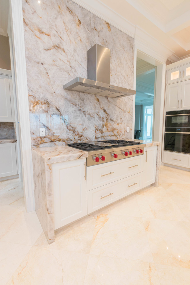 Huge transitional u-shaped marble floor and white floor open concept kitchen photo with an undermount sink, flat-panel cabinets, white cabinets, quartzite countertops, white backsplash, stone slab backsplash and two islands