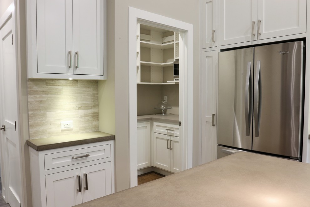 Large transitional l-shaped dark wood floor open concept kitchen photo in Grand Rapids with an undermount sink, shaker cabinets, white cabinets, quartz countertops, beige backsplash, porcelain backsplash, stainless steel appliances and an island
