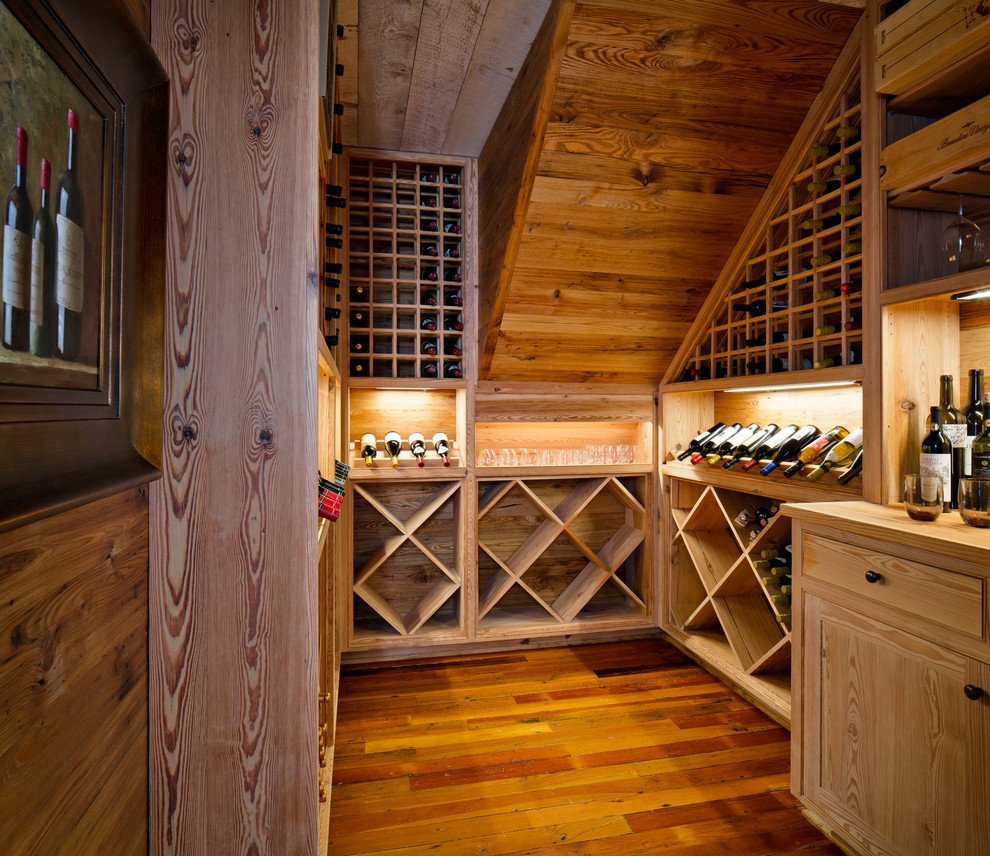 Inspiration for a mid-sized traditional wine cellar in New Orleans with medium hardwood floors and diamond bins.