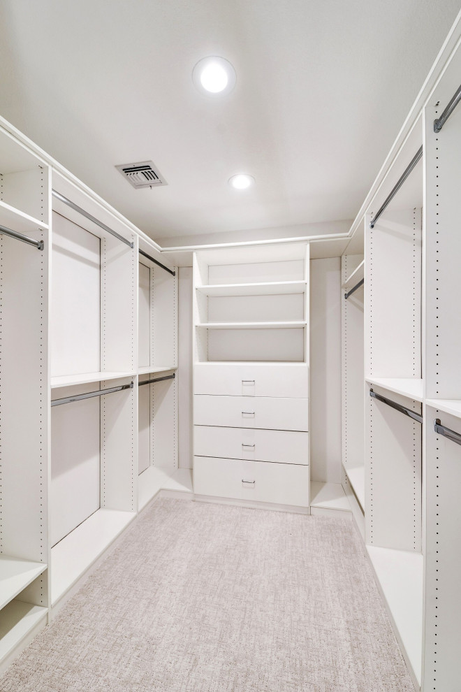 Medium sized classic gender neutral walk-in wardrobe in Phoenix with flat-panel cabinets, white cabinets, carpet and beige floors.