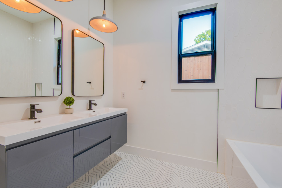 Идея дизайна: детская ванная комната среднего размера в стиле модернизм с серыми фасадами, угловой ванной, открытым душем, унитазом-моноблоком, белой плиткой, плиткой из сланца, белыми стенами, мраморным полом, накладной раковиной, столешницей из искусственного камня, белым полом, шторкой для ванной, белой столешницей, тумбой под две раковины и подвесной тумбой