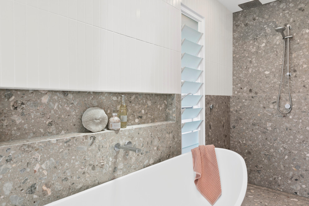 This is an example of a large contemporary grey and white ensuite bathroom in Sydney with beaded cabinets, light wood cabinets, a freestanding bath, a walk-in shower, a one-piece toilet, white tiles, ceramic tiles, white walls, marble flooring, a vessel sink, marble worktops, grey floors, an open shower, grey worktops, feature lighting, double sinks and a built in vanity unit.