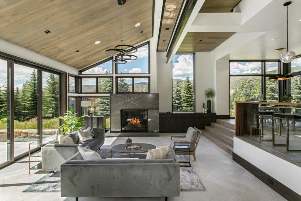Offenes Uriges Wohnzimmer mit weißer Wandfarbe, grauem Boden, gewölbter Decke und Holzdecke in Denver