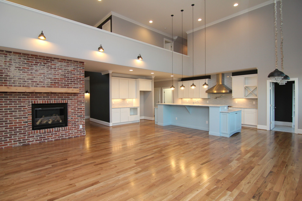 Large contemporary kitchen in Raleigh with light hardwood floors.