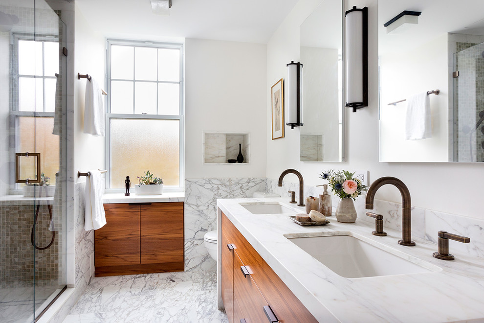 Inspiration for a mid-sized transitional master bathroom in New York with an undermount sink, flat-panel cabinets, medium wood cabinets, marble benchtops, gray tile, stone slab, white walls and marble floors.