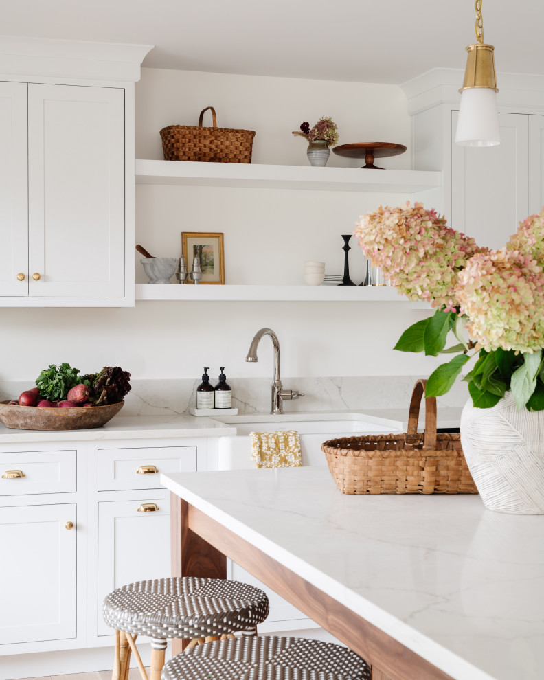 Country kitchen photo in Boston with a farmhouse sink, shaker cabinets, white cabinets, quartz countertops and beige countertops