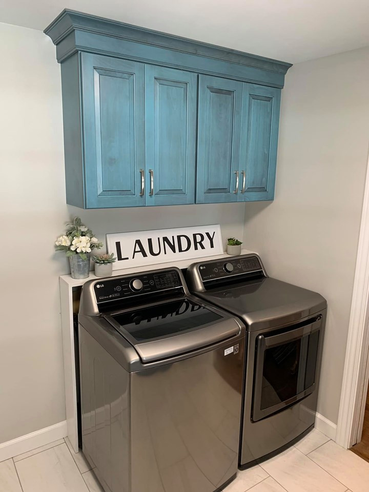 Mid-sized country galley utility room in Chicago with an undermount sink, raised-panel cabinets, turquoise cabinets, quartz benchtops, grey walls, porcelain floors, a side-by-side washer and dryer, grey floor and white benchtop.