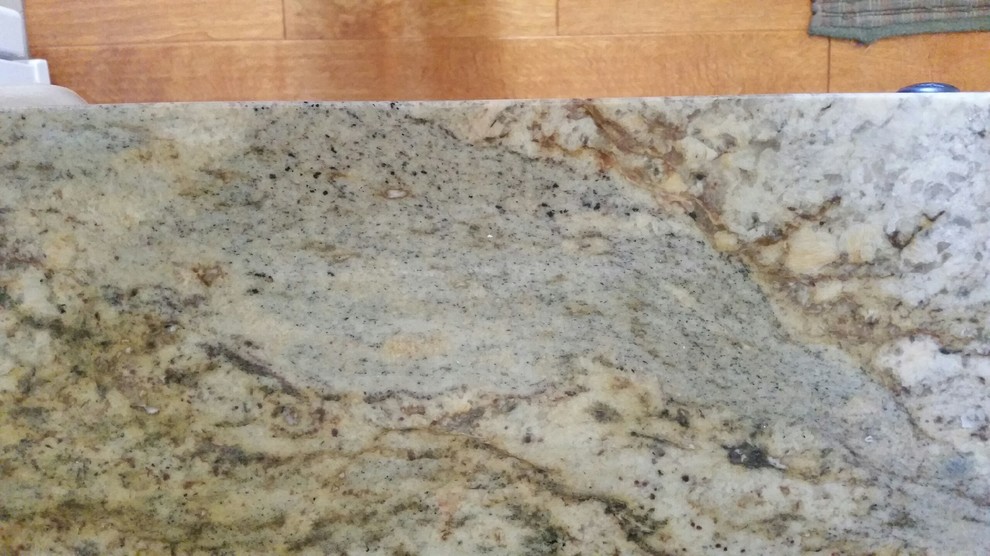 Example of a mid-sized transitional u-shaped eat-in kitchen design in Seattle with an undermount sink, recessed-panel cabinets, distressed cabinets, granite countertops, beige backsplash, stone tile backsplash, white appliances and a peninsula