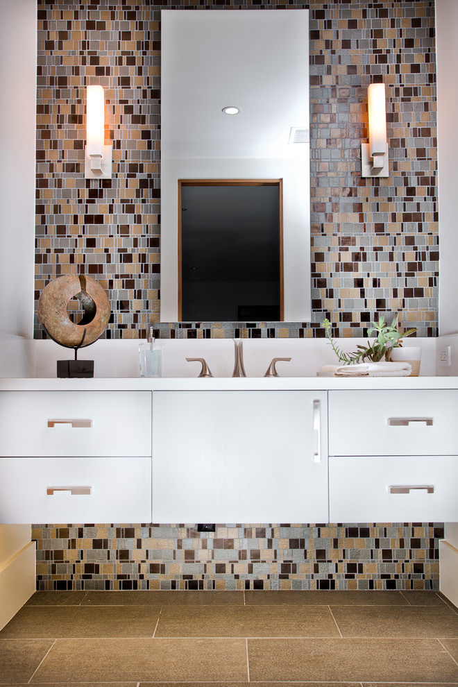 Inspiration for a contemporary bathroom in Orange County with flat-panel cabinets, white cabinets, multi-coloured tile, mosaic tile, white walls, brown floor and white benchtops.