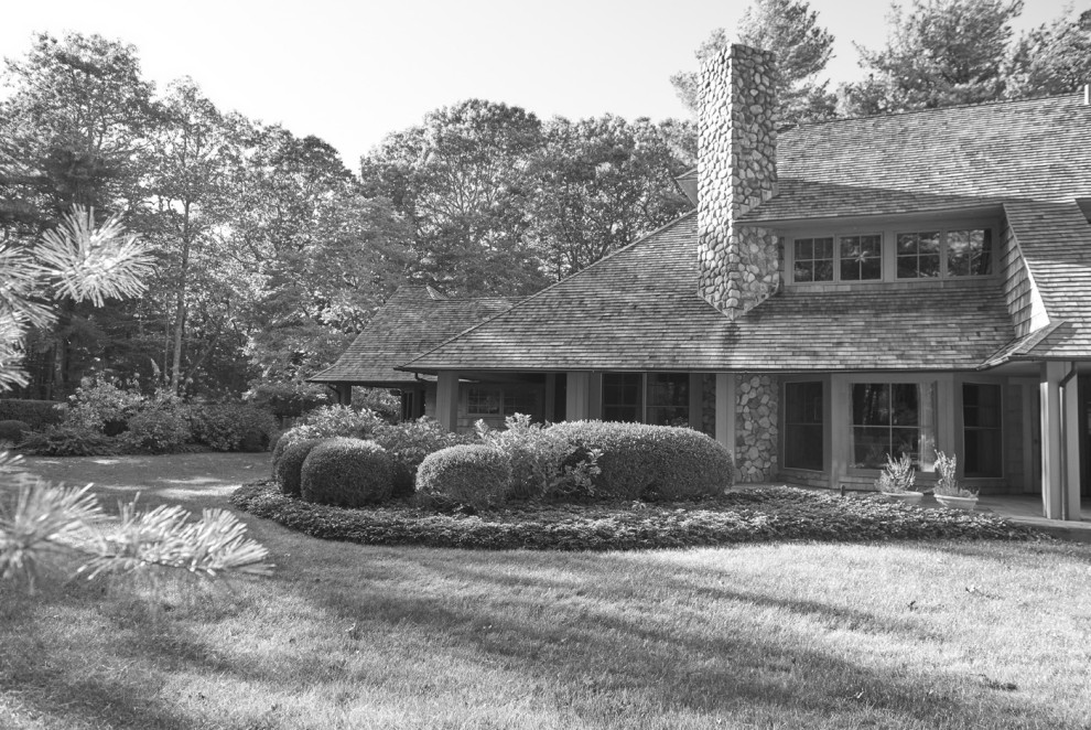 This is an example of a large traditional house exterior in New York with a shingle roof.