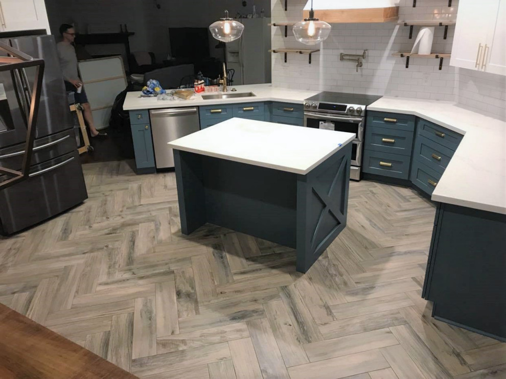 Inspiration for a mid-sized transitional u-shaped eat-in kitchen in Houston with turquoise cabinets, white splashback, stainless steel appliances, laminate floors, with island, beige floor, white benchtop, coffered, an undermount sink, shaker cabinets, quartzite benchtops and ceramic splashback.