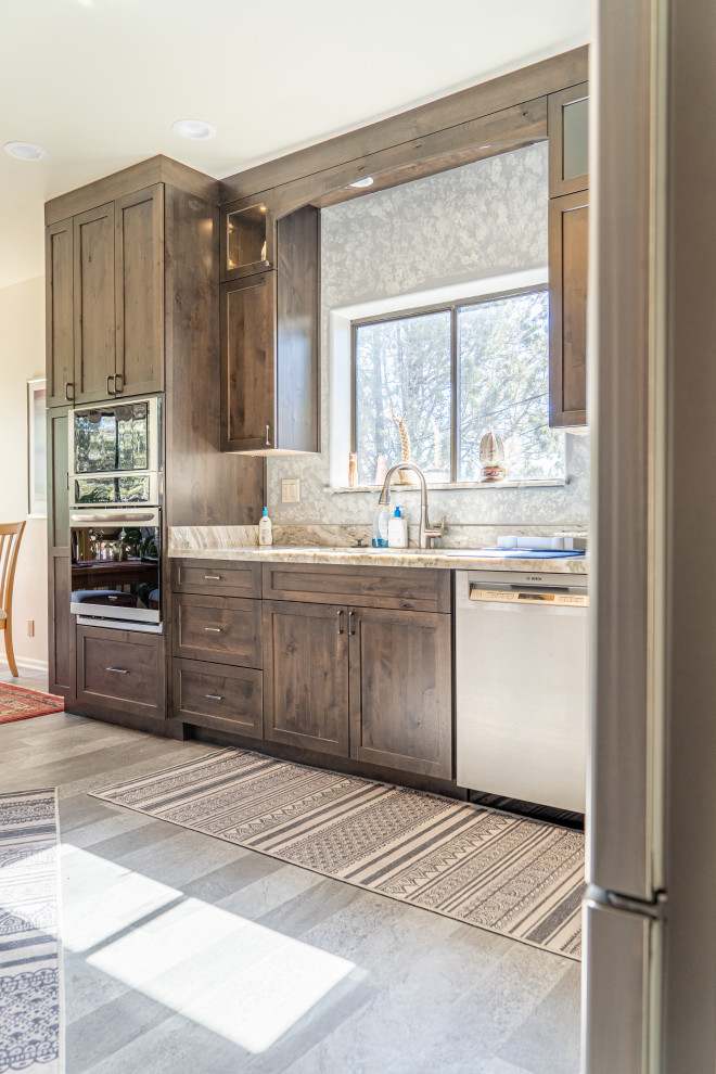 Inspiration for a transitional kitchen remodel with shaker cabinets, medium tone wood cabinets and an island