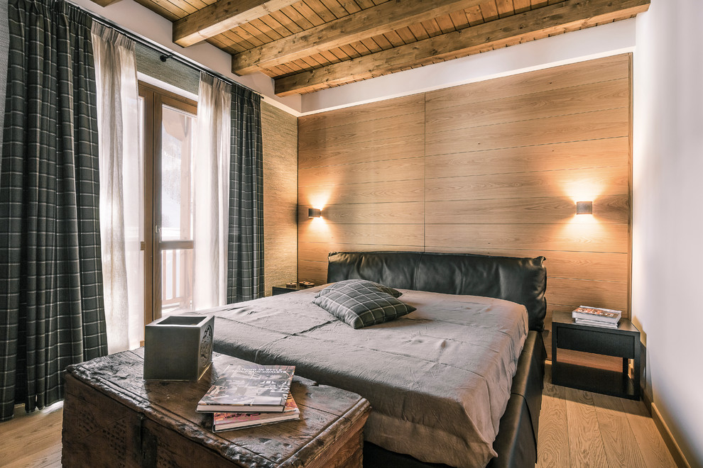 Mid-sized country master bedroom in Turin with light hardwood floors.