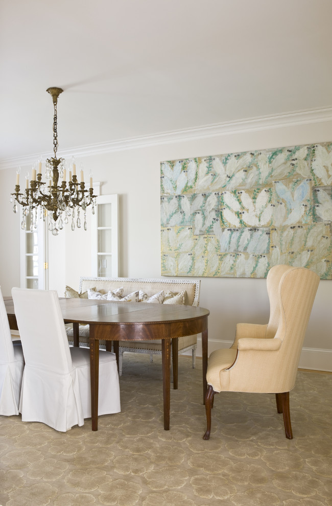 Photo of a traditional dining room in DC Metro with beige walls and carpet.