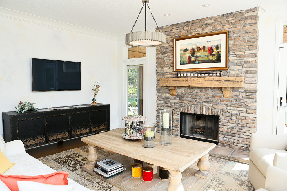 Photo of a mid-sized transitional open concept family room in Minneapolis with white walls, medium hardwood floors, a standard fireplace, a stone fireplace surround and a wall-mounted tv.