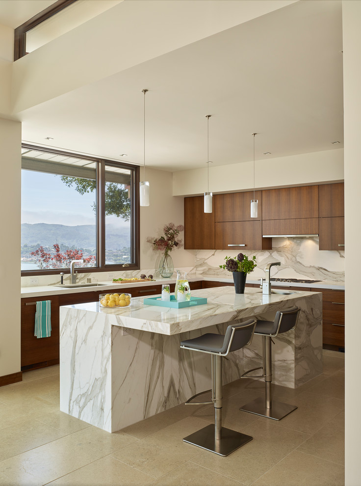 Design ideas for a contemporary l-shaped kitchen in San Francisco with an undermount sink, flat-panel cabinets, medium wood cabinets, white splashback, marble splashback, with island and beige floor.