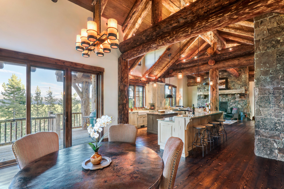 Large mountain style u-shaped medium tone wood floor and brown floor eat-in kitchen photo with distressed cabinets, granite countertops, stainless steel appliances, an island and beige countertops