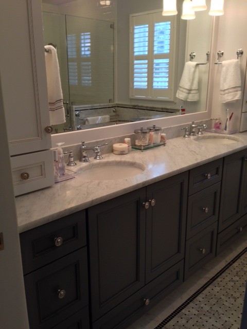 Photo of a traditional bathroom in New York with grey cabinets and marble benchtops.