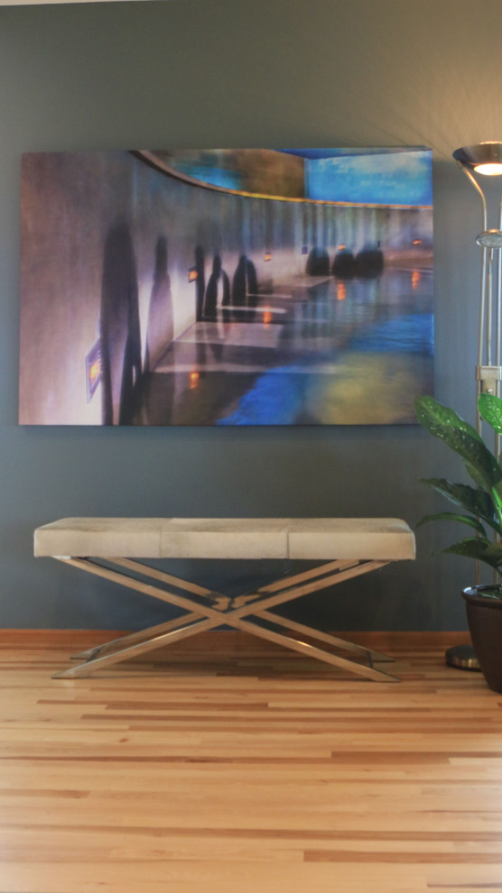 Mid-sized transitional medium tone wood floor and brown floor foyer photo in Omaha with blue walls
